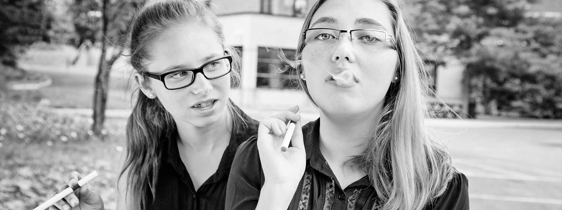 Two young middle school girls trying vape
